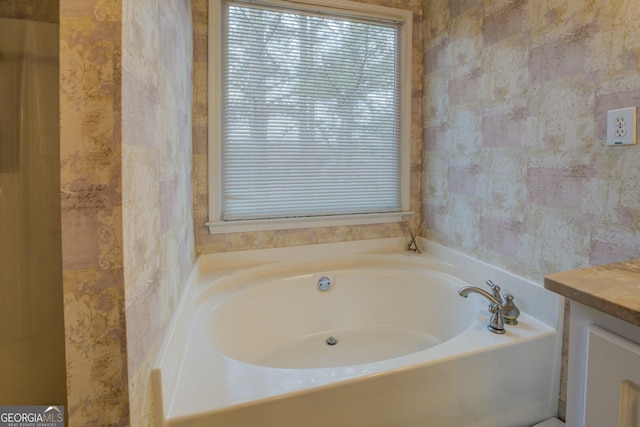 bathroom featuring vanity and a tub to relax in