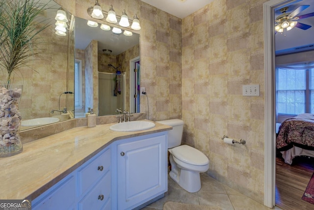 bathroom featuring tile walls, vanity, walk in shower, toilet, and tile patterned floors