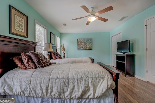 bedroom featuring wood-type flooring and ceiling fan