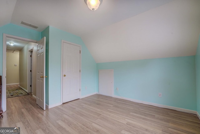 bonus room with vaulted ceiling and light hardwood / wood-style floors