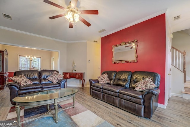 living room with crown molding, ceiling fan with notable chandelier, and light wood-type flooring