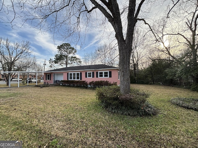 ranch-style home with a front yard and a carport