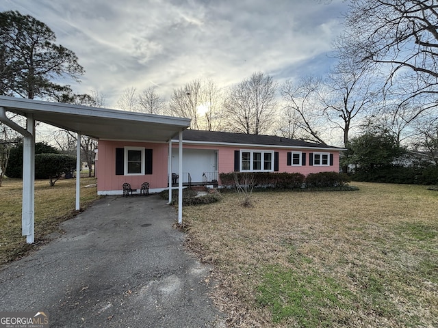 single story home with a front yard and a carport