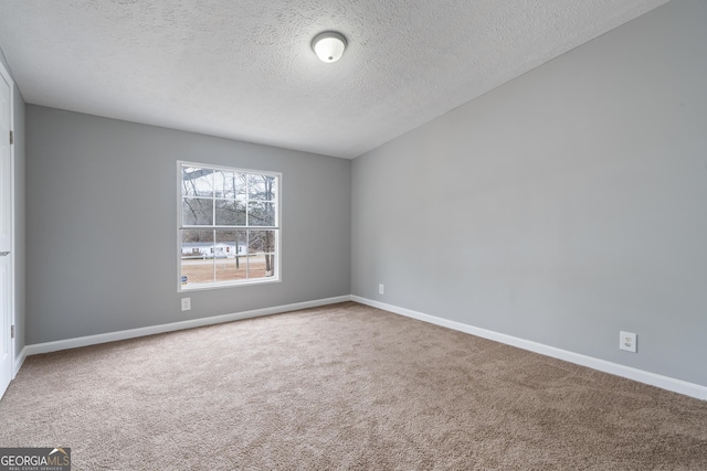 carpeted spare room featuring a textured ceiling