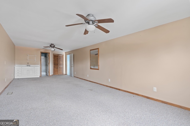 unfurnished living room with carpet flooring and ceiling fan