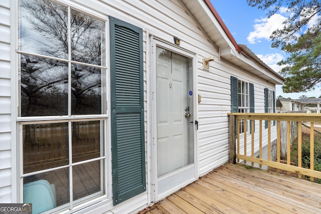 view of exterior entry with a deck