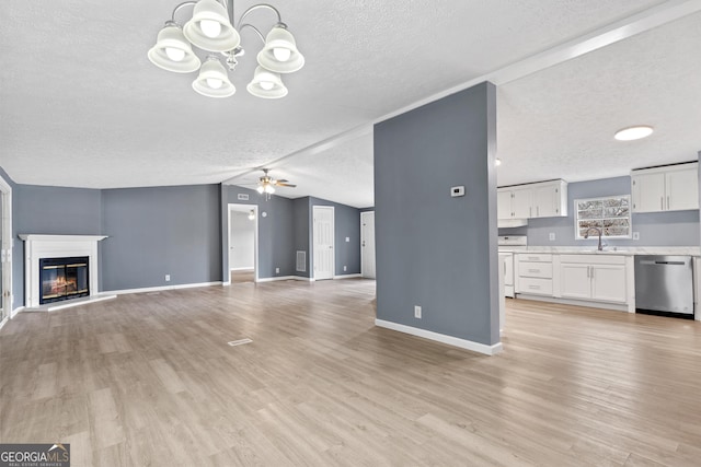 unfurnished living room featuring vaulted ceiling, sink, ceiling fan with notable chandelier, and light hardwood / wood-style flooring