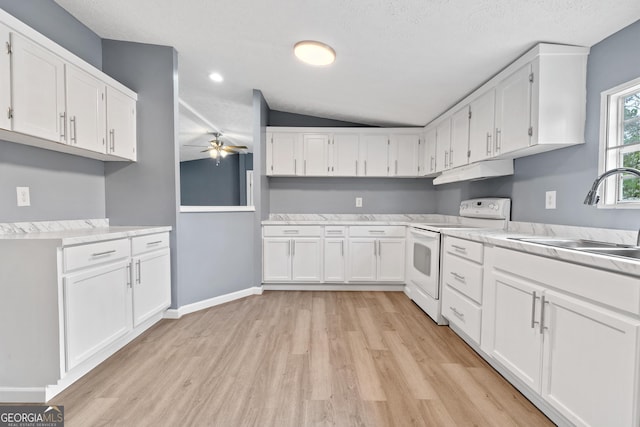 kitchen featuring white electric range oven, sink, vaulted ceiling, light wood-type flooring, and white cabinets