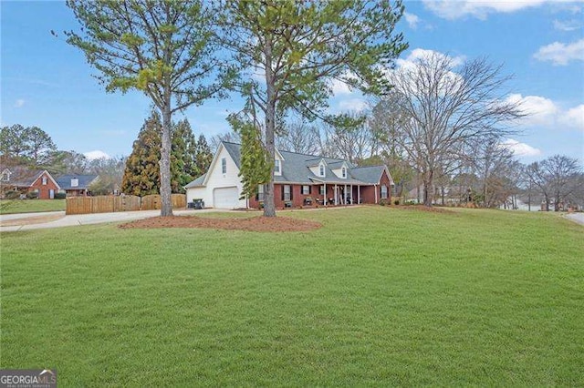 view of front of house with a garage and a front lawn