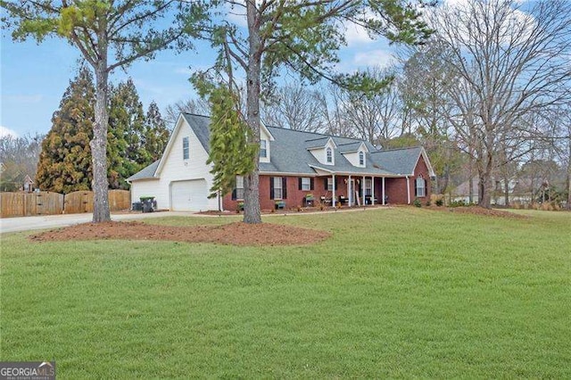 cape cod house featuring a garage and a front yard