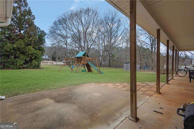 view of patio / terrace featuring a playground and a storage unit