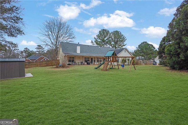 exterior space featuring a storage shed and a lawn