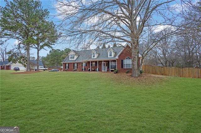 cape cod home with a front yard