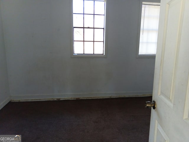 empty room featuring dark colored carpet