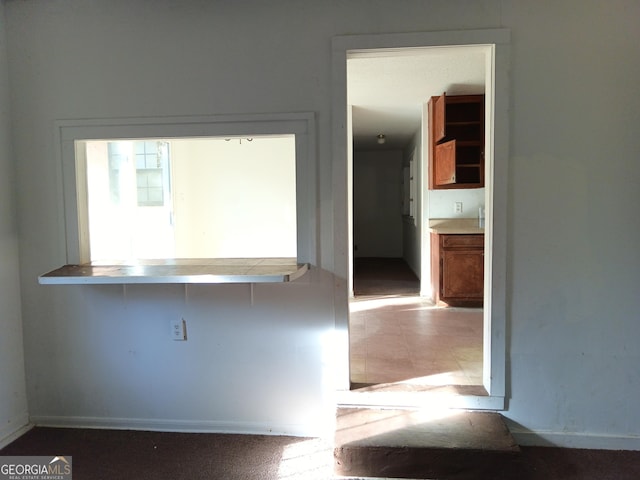 kitchen with brown cabinetry and light countertops