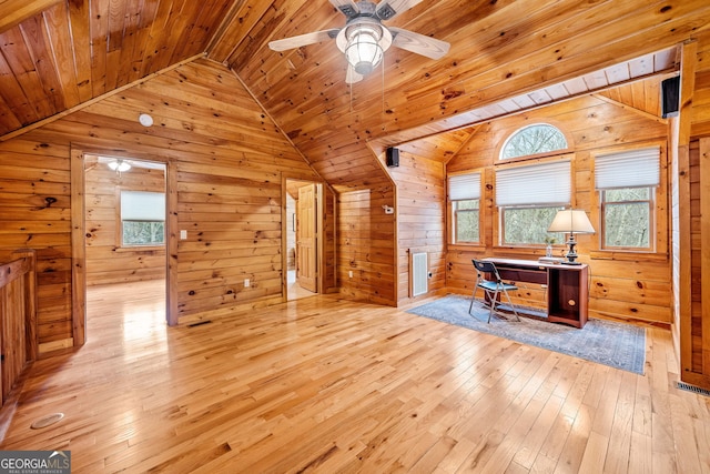 office space featuring light wood-type flooring, lofted ceiling, wooden walls, and wood ceiling