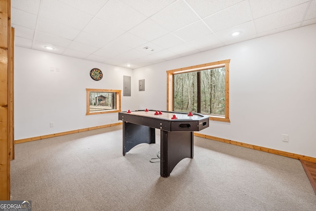 rec room featuring carpet, electric panel, and a paneled ceiling