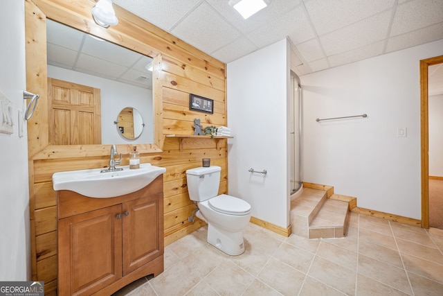 bathroom featuring an enclosed shower, tile patterned floors, toilet, a paneled ceiling, and vanity