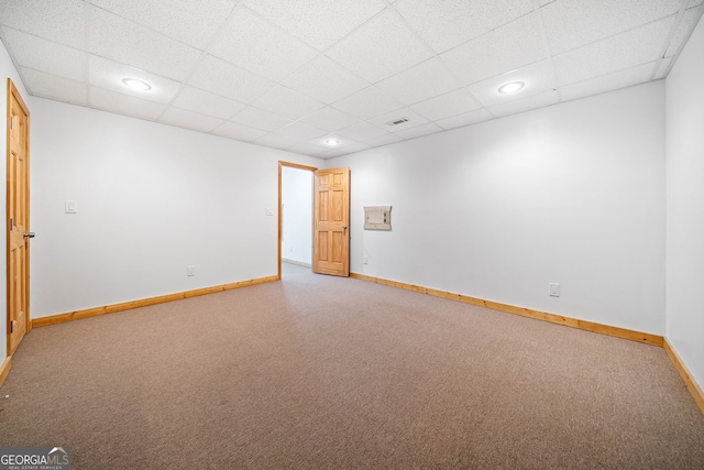 carpeted spare room featuring a paneled ceiling