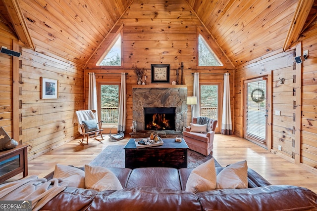 living room with wooden walls, wooden ceiling, and light hardwood / wood-style floors