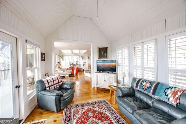 sunroom / solarium featuring lofted ceiling