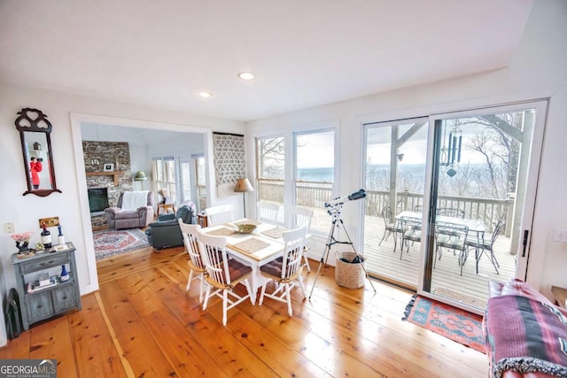 dining space featuring hardwood / wood-style floors and a fireplace