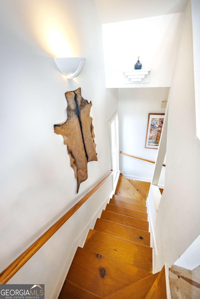 stairs with hardwood / wood-style flooring