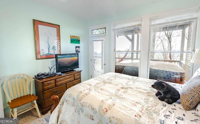 bedroom featuring carpet flooring and access to outside