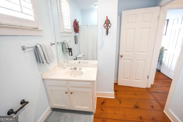 bathroom featuring vanity, plenty of natural light, hardwood / wood-style floors, and walk in shower