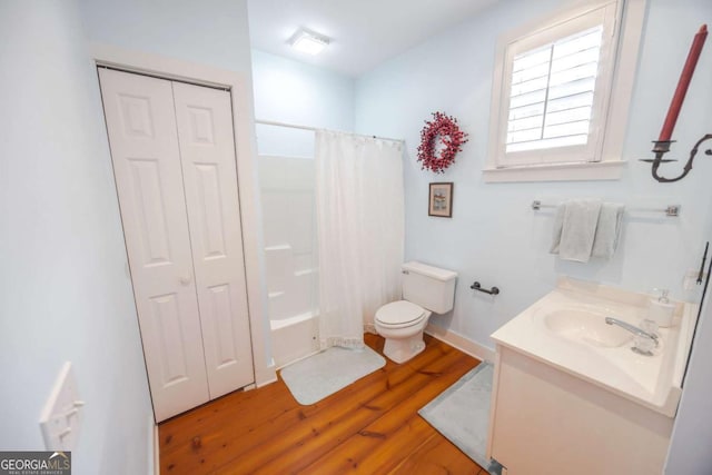 full bathroom with vanity, hardwood / wood-style floors, shower / bath combination with curtain, and toilet