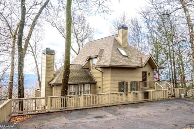 rear view of house featuring a deck