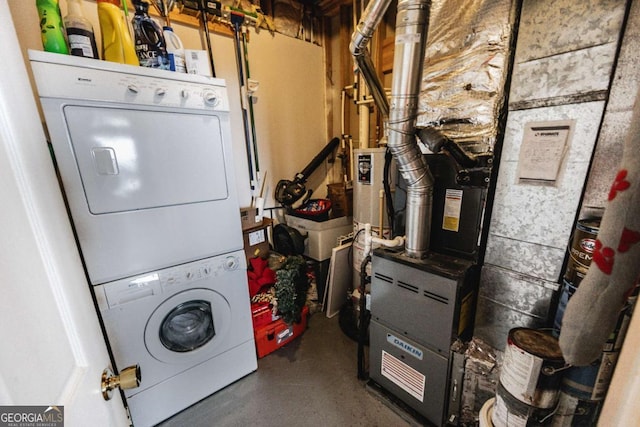 clothes washing area with stacked washer / dryer