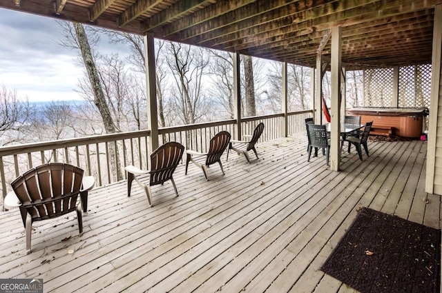 wooden terrace featuring a hot tub