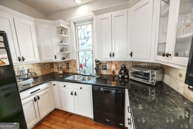 kitchen with tasteful backsplash, white cabinetry, sink, dark stone counters, and black appliances