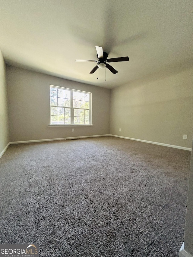 spare room featuring carpet flooring and ceiling fan