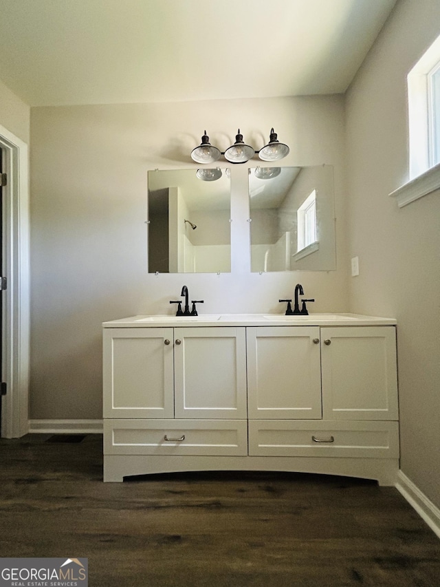 bathroom with vanity and hardwood / wood-style flooring