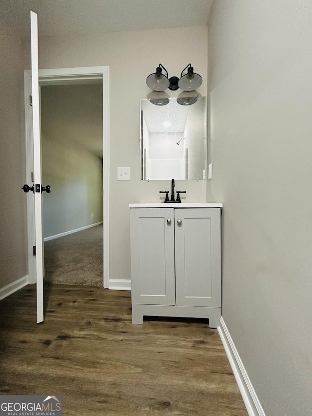 bathroom with vanity and hardwood / wood-style floors