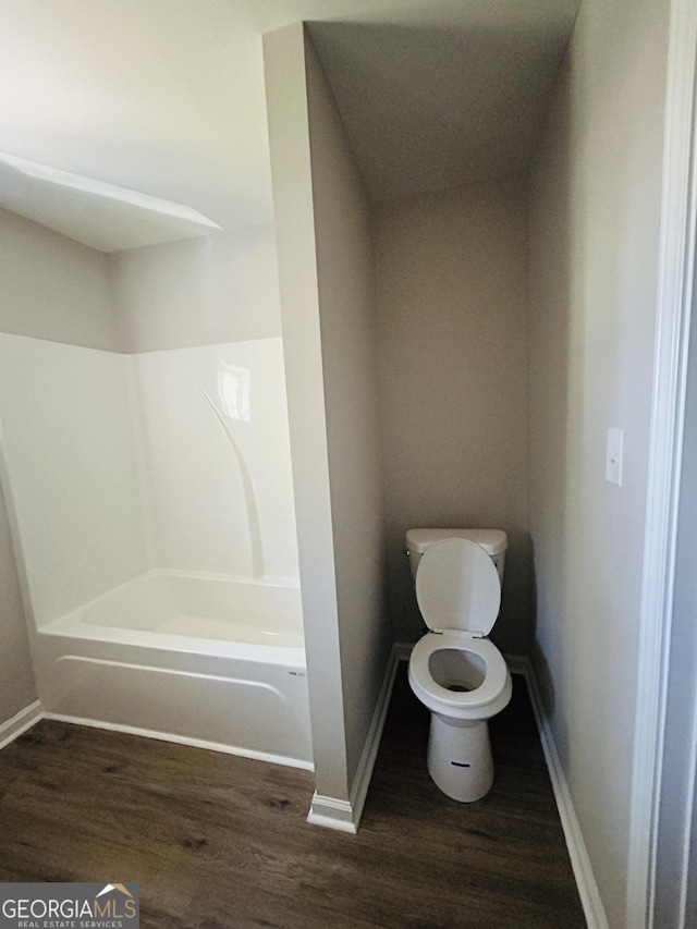 bathroom featuring a bathtub, wood-type flooring, and toilet