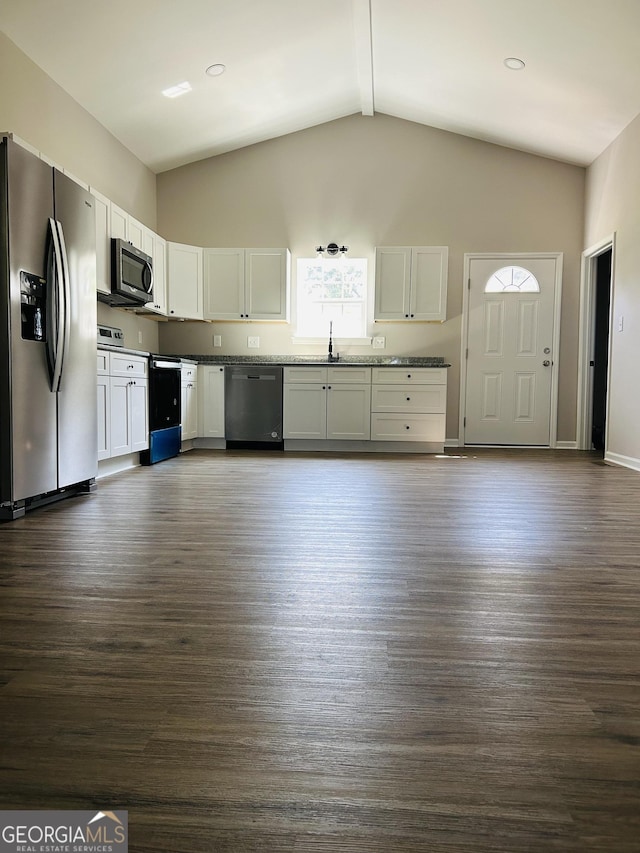 kitchen featuring stainless steel appliances, dark wood-type flooring, white cabinets, and high vaulted ceiling