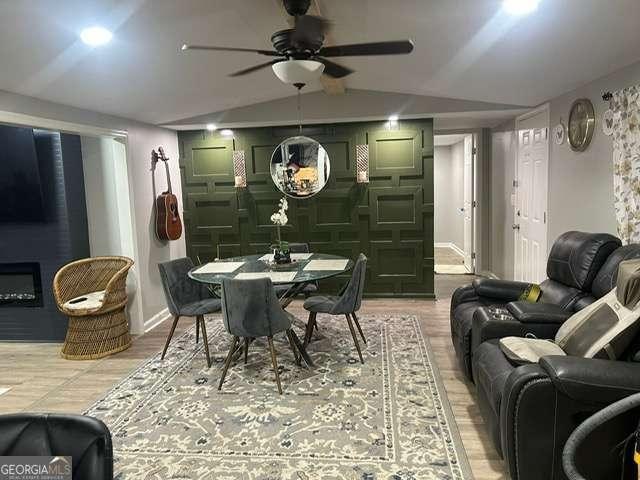 dining area with lofted ceiling, hardwood / wood-style flooring, and ceiling fan