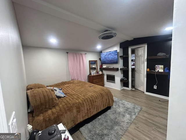 bedroom featuring lofted ceiling with beams and wood-type flooring