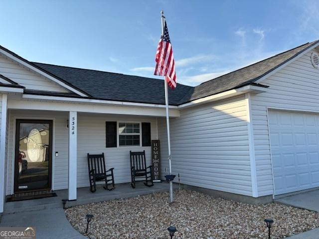 exterior space featuring a porch and a garage