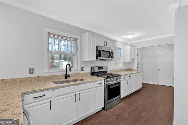 4138 Hickory Dr, Powder Springs, GA 30127 - kitchen featuring appliances with stainless steel finishes, dark hardwood / wood-style floors, sink, white cabinets, and crown molding
