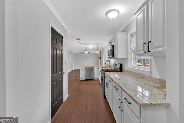 4138 Hickory Dr, Powder Springs, GA 30127 - kitchen with dark wood-type flooring, stainless steel appliances, light stone countertops, white cabinets, and decorative light fixtures