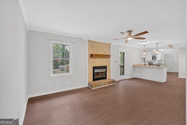 4138 Hickory Dr, Powder Springs, GA 30127 - unfurnished living room with crown molding, ceiling fan, a fireplace, and dark wood-type flooring