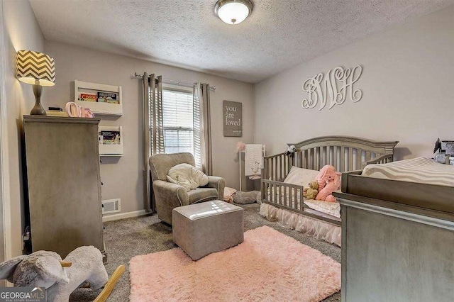 bedroom featuring a textured ceiling and carpet flooring