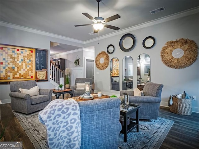 living room featuring crown molding, wood-type flooring, and ceiling fan