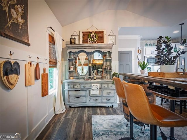 interior space with dark hardwood / wood-style flooring and vaulted ceiling