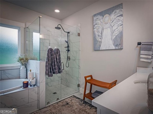 bathroom featuring vanity and separate shower and tub