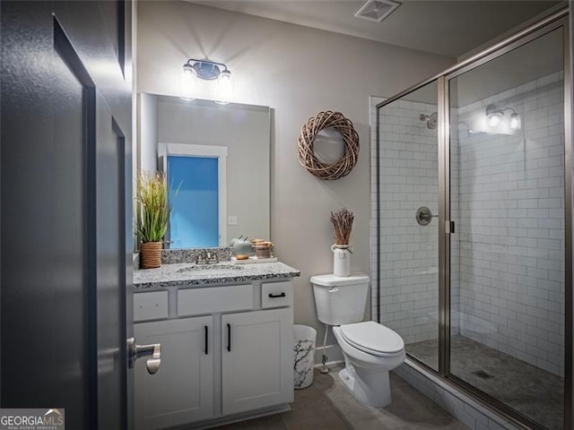 bathroom featuring vanity, toilet, tile patterned flooring, and a shower with door